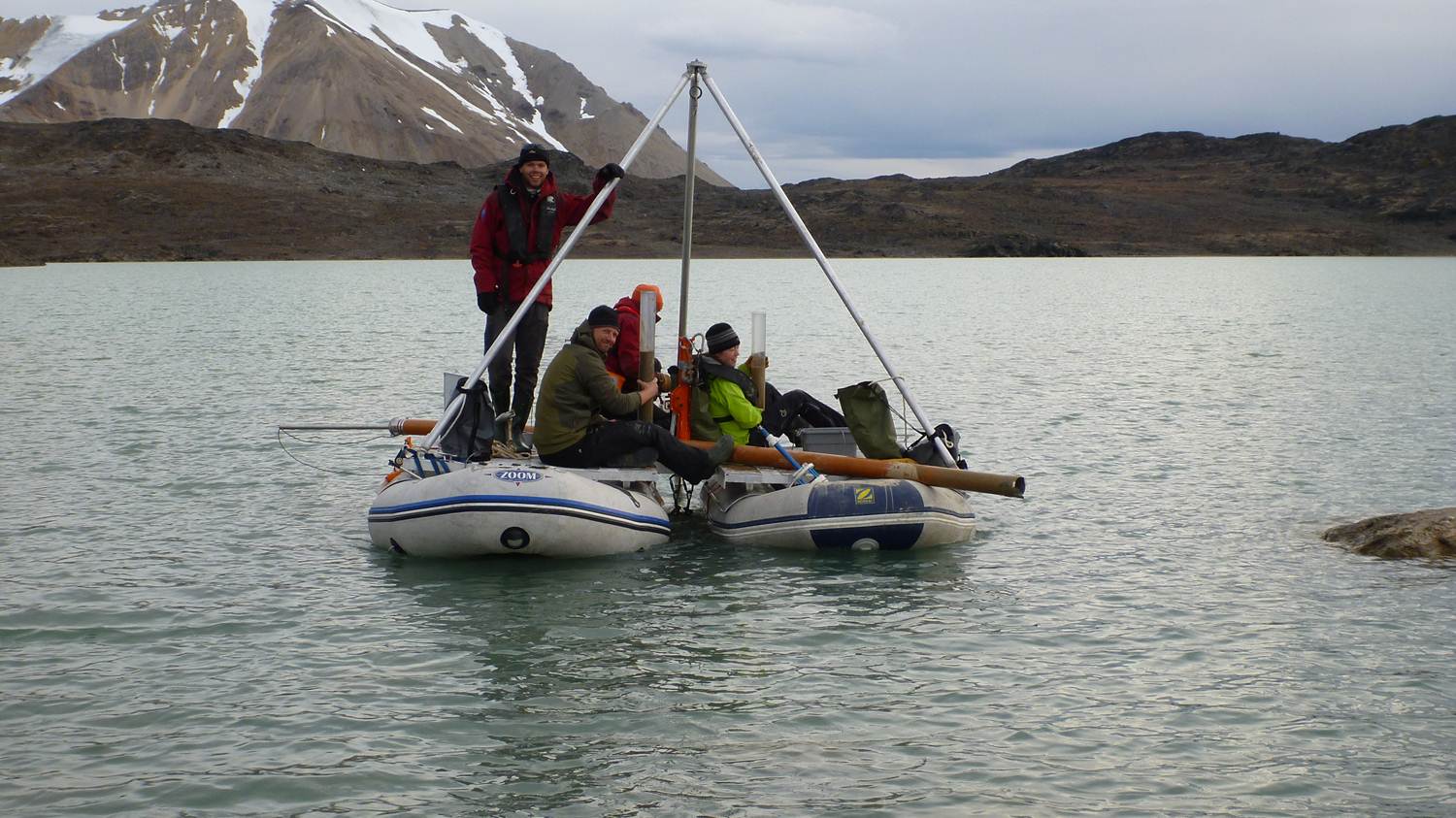 With a basic coring rig and two inflatable rafts lashed together to form a platform, scientists on Svalbard can extract sediments from the lakebed below
